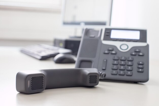 Photo classical black telephone in the office customer support and telesale