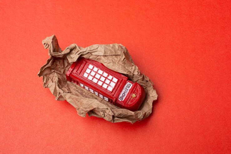 Premium Photo | Classical british style red phone booth on brown paper