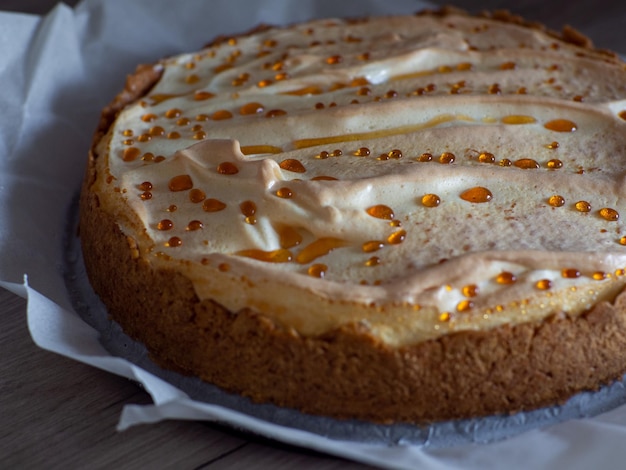 Classical cheesecake with meringue on white paper background