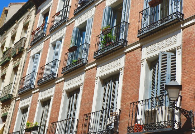 Classical facades of pastel colours vintage balconies shutters Sol district downtown Madrid Spain