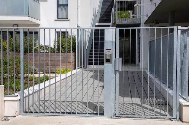 Photo classical gate and entrance door to the building and access to the apartments with digital code keyboard