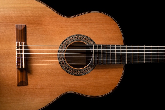 Classical guitar on black background acoustic guitar\
conceptperfect for flyer card poster or wallpaper