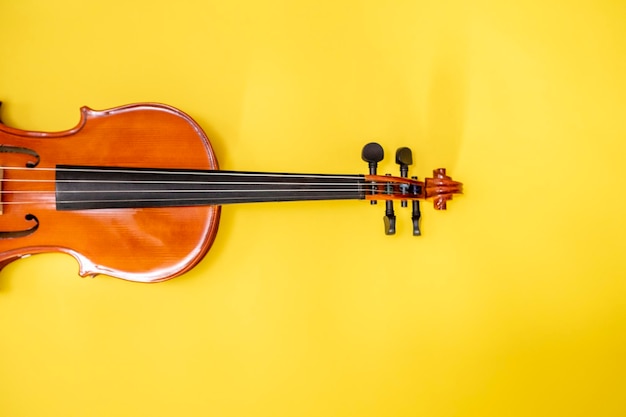 Photo classical music concert poster with orange color violin on yellow background with copy space for