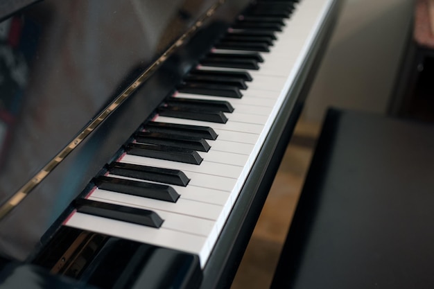 Classical piano keyboard with seat Side view