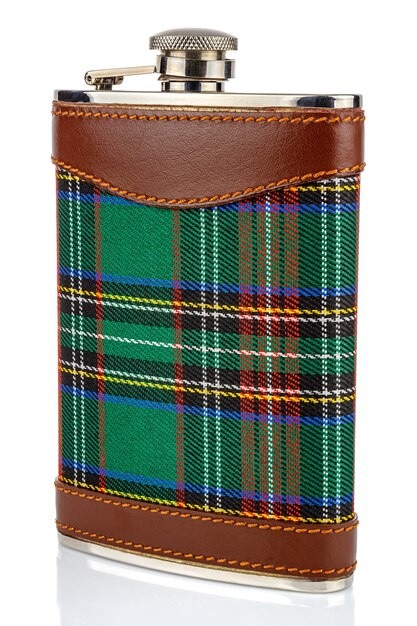 Classical scotland pewter hip flask with leather and tartan trim isolated on white