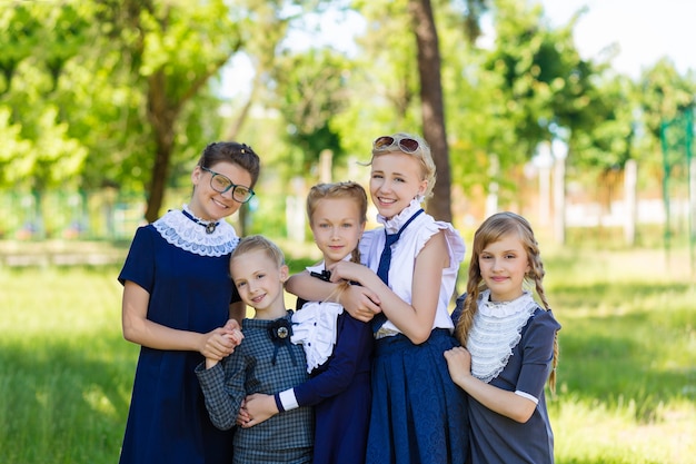 Classmate girls in school uniform are standing in the park