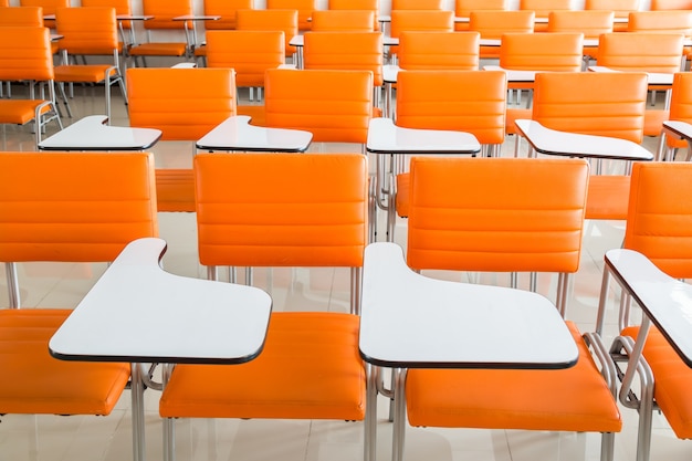 classroom with many orange armchairs background