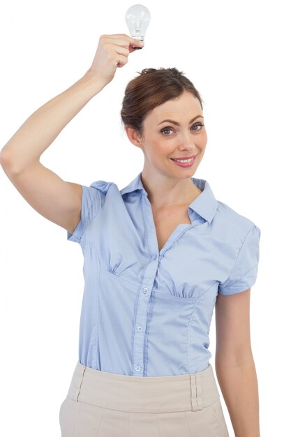 Classy businesswoman holding light bulb 