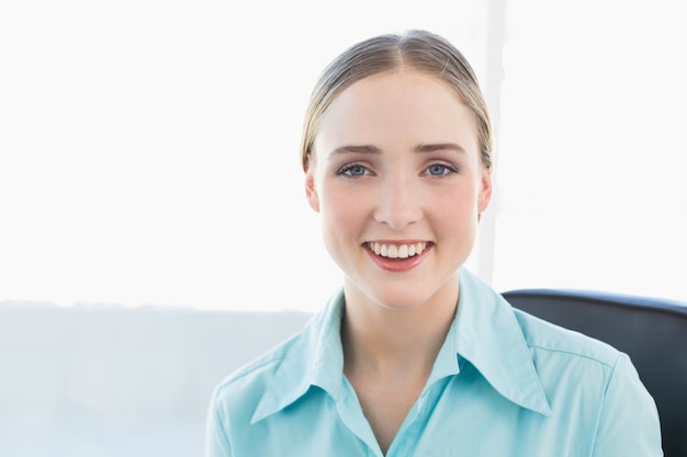 Classy smiling businesswoman looking at camera