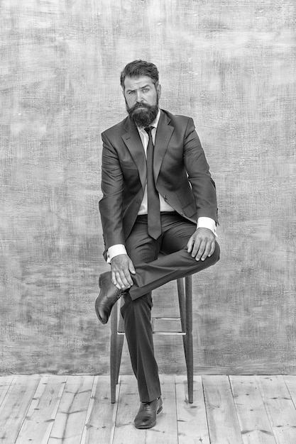 Classy style is timeless stylish businessman sit on chair\
bearded man in formal style professional wardrobe business dress\
code and formalwear fashion style real man real style vintage\
filter