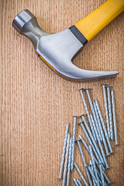 Claw hammer and nails on wooden boards