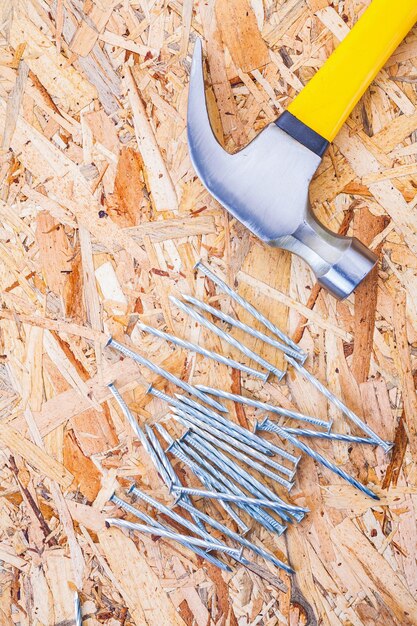 Claw hammer with nails on plywood