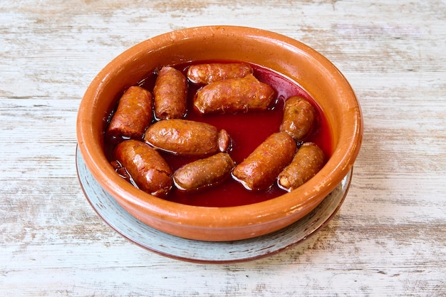 clay casserole with chorizos in cider