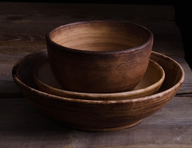 Clay dishes on an old wooden table