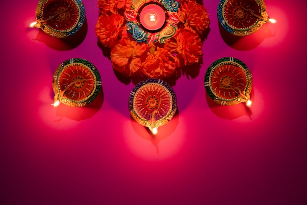 Clay Diya-lampen die tijdens Dipavali worden aangestoken vieren op roze achtergrond