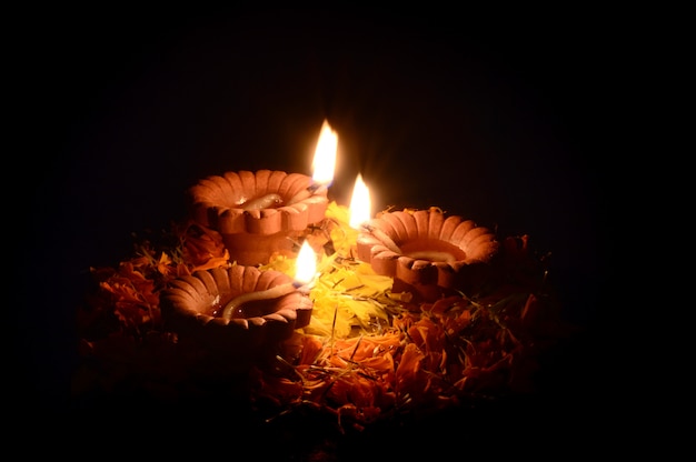 Clay diya lamps lit during Diwali Celebration. Greetings Card Design Indian Hindu Light Festival called Diwali