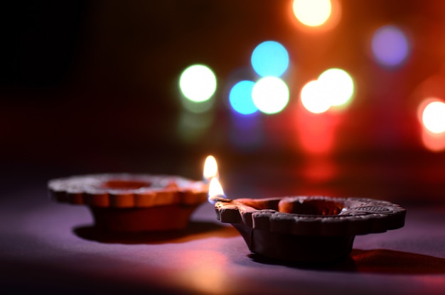 Clay diya lamps lit during Diwali Celebration. Greetings Card Design Indian Hindu Light Festival called Diwali