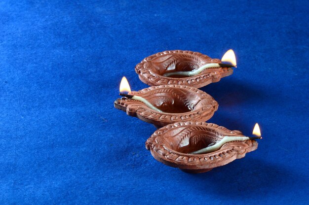 Clay diya lamps lit during diwali celebration. Greetings Card Design Indian Hindu Light Festival called Diwali