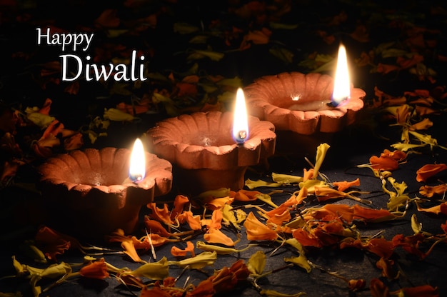 Clay diya lamps lit during Diwali Celebration. Greetings Card Design Indian Hindu Light Festival called Diwali