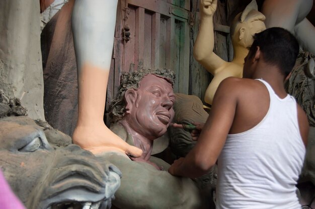 Clay idol of goddess durga under preparation for bengals durga puja festival at kumartuli kolkata