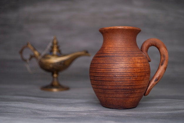 Clay jug on a gray background