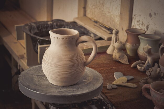 Clay jug on a potter's wheel close-up. Copy spase