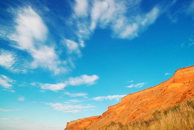 Clay mountain on a background of blue sky