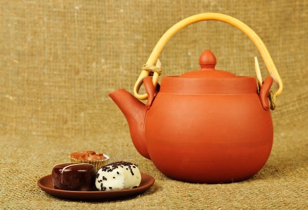 Clay teapot with sweets