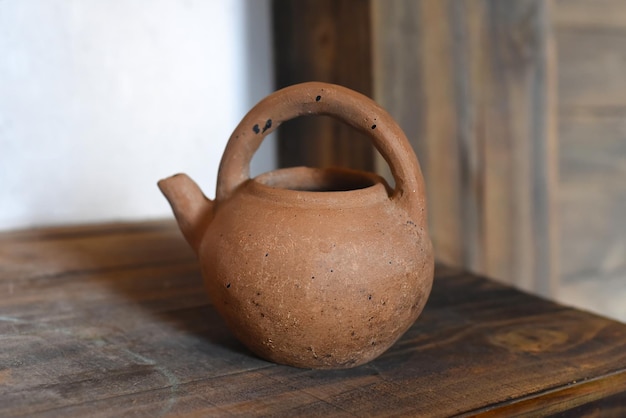 Clay teapot on a wooden table