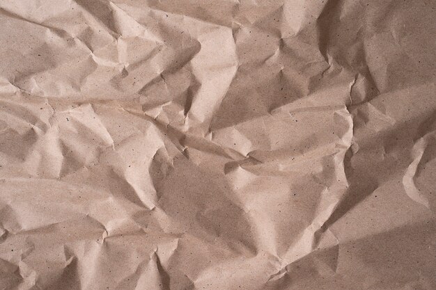 Clean beige recycle paper, wrinkled, abstract background for design. Texture of beige crumpled paper for background or wallpaper, close up image in high resolution