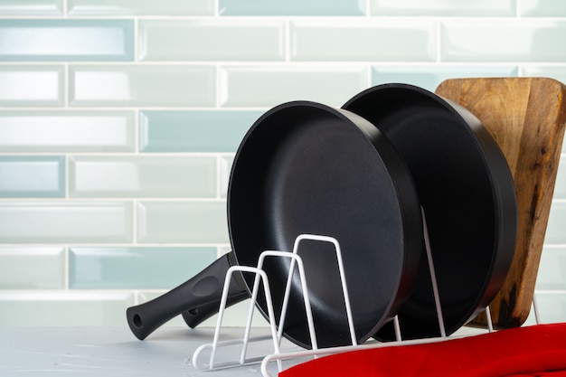 Clean and dry cooking pans on a kitchen counter