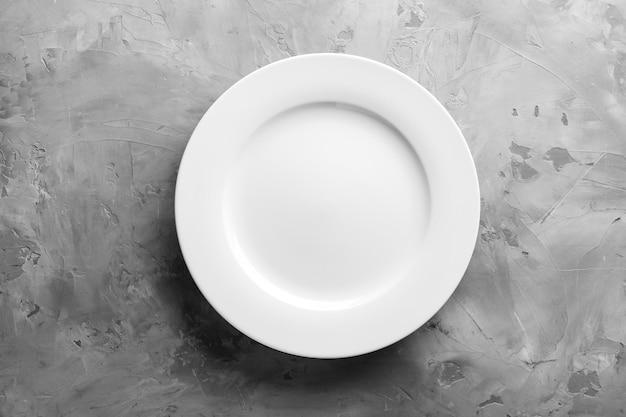 Clean empty plate on grey surface