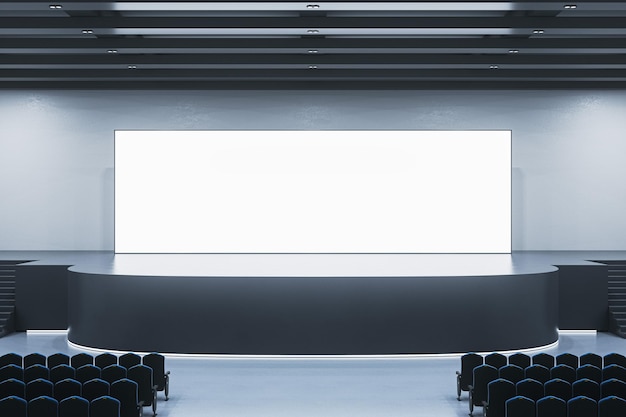 Clean exhibition hall interior with illuminated empty white mock up banner on stage Auditorium and advertisement concept