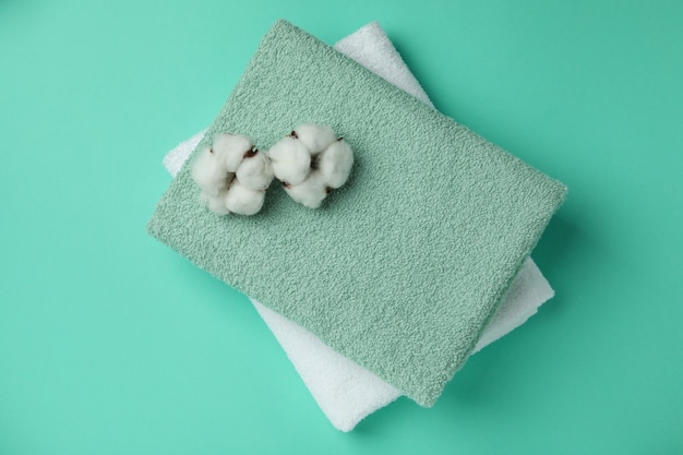 Clean folded towels and cotton on mint