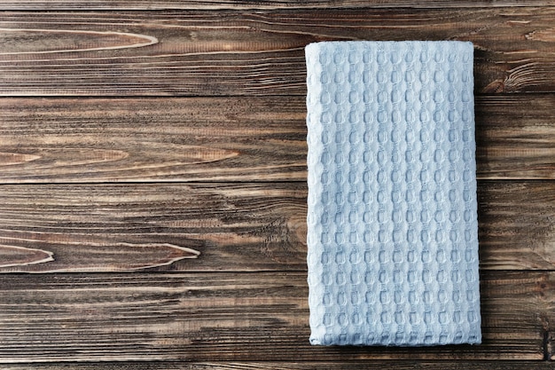Clean kitchen towel on wooden table top view