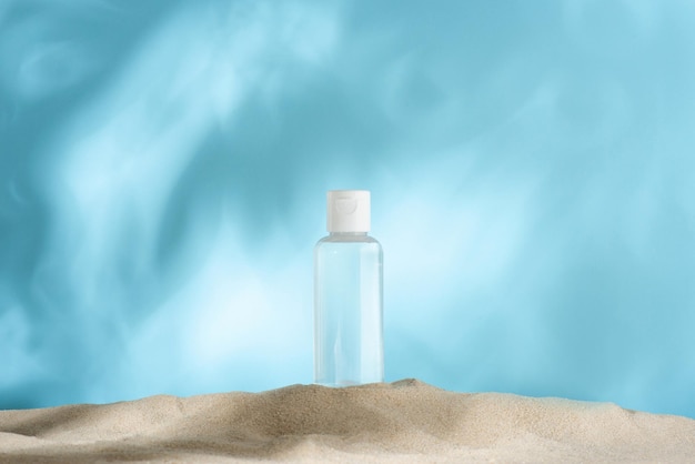 Clean small bottle of micellar water facial toner on the sand