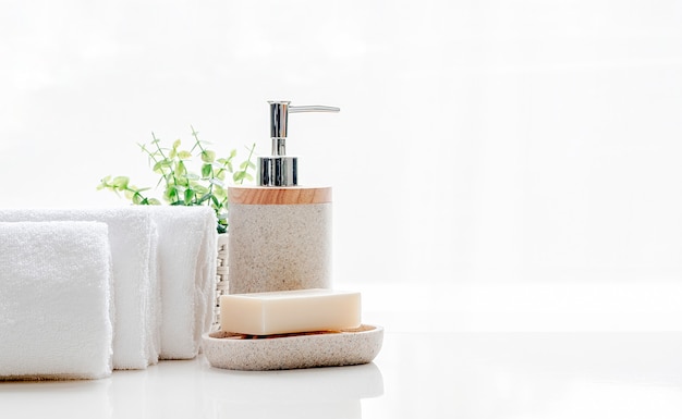 Clean soft terry towels with soap on white table, copy space.