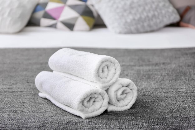 Clean soft towels on bed