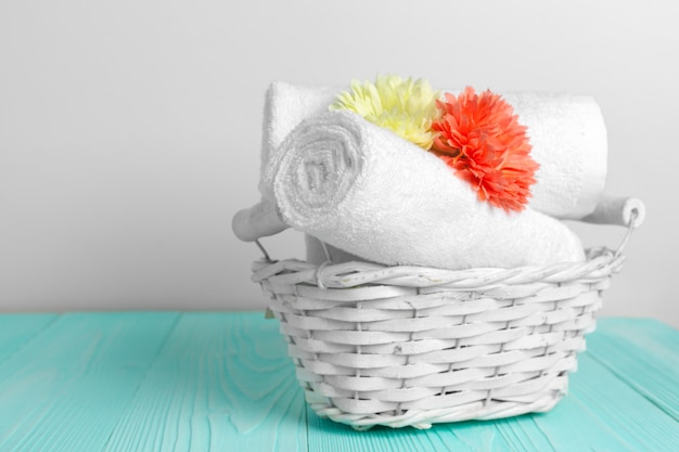 clean soft towels with flower on wooden table