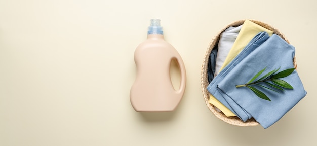 Clean washed clothes with bottle packaging of detergent for\
laundry