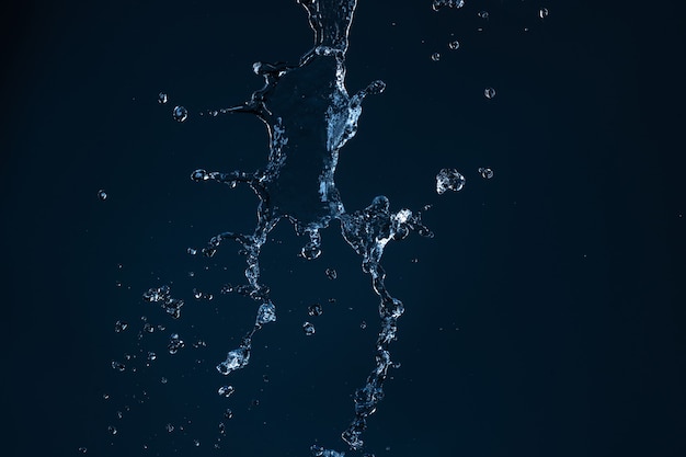 Clean water jet falling on an empty black background