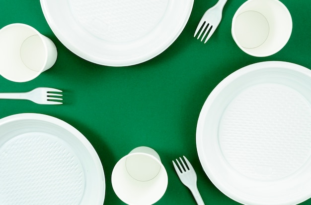 Clean white dishes on green background