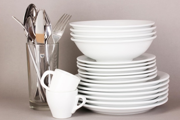 Clean white dishes on grey background