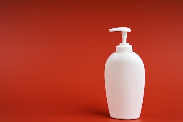 Clean white plastic bottle with soap dispenser.