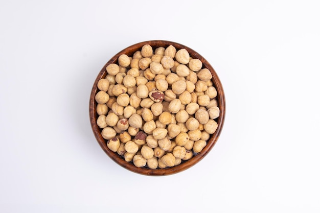 Cleaned Hazelnuts in a wooden bowl top view