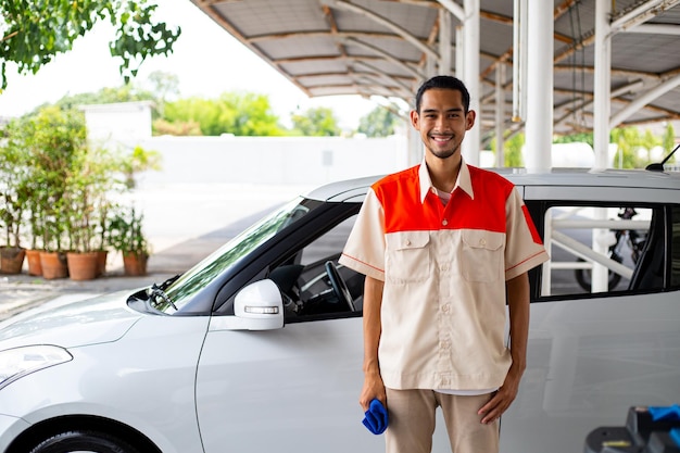 Photo cleaner car service adult with uniform for clean vehicle to customer.smart worker car care prepare equipment for vacuum dust.
