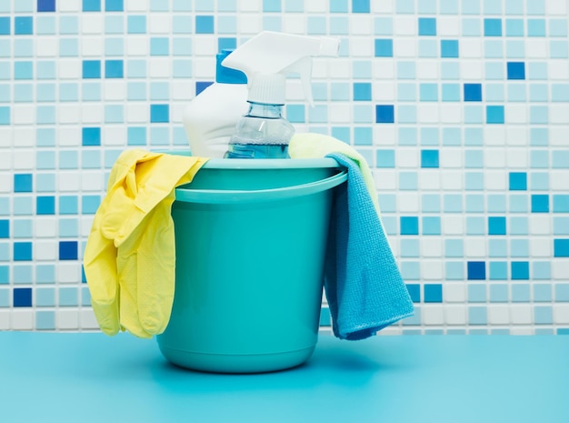 Cleaners and detergents in bucket accessories for cleaning various surfaces and rooms blue background