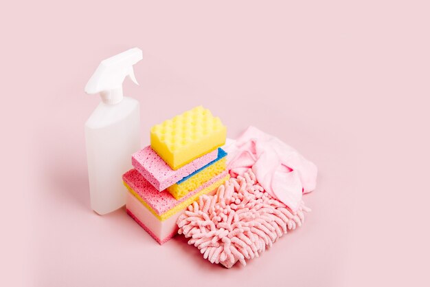 Cleaning accessories  in pink color.  Cleaning service concept. Flat lay, Top view.