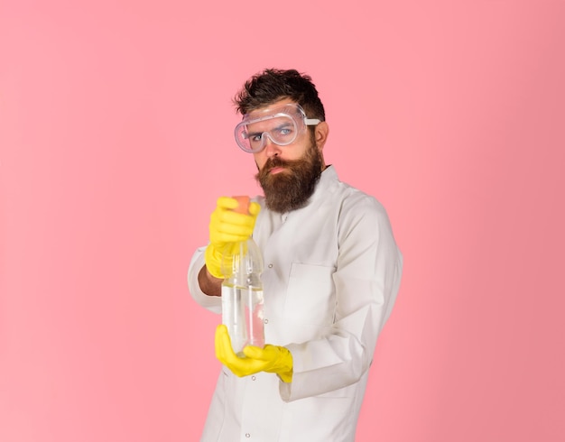 Cleaning advertising bearded man in uniform and rubber gloves holds cleanser spray cleaners cleaning