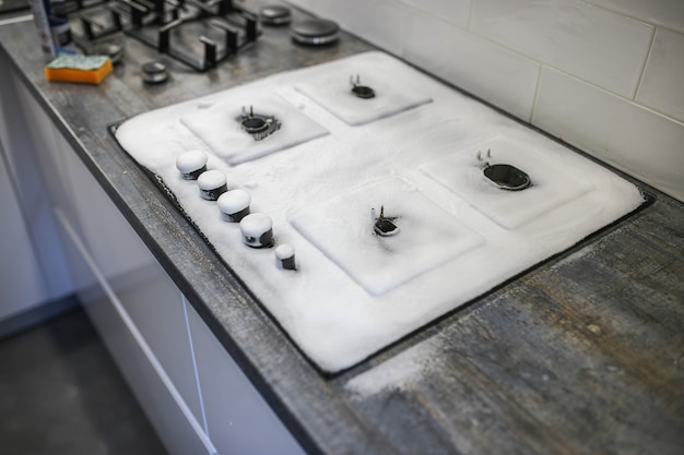 cleaning agent foam on a gas stove cleaning the kitchen